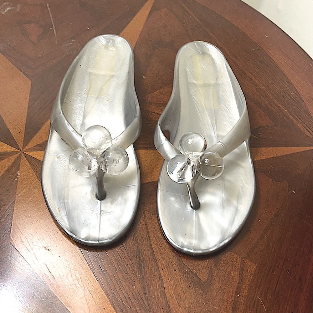 Adorable flip flops in silver w/lucite balls.